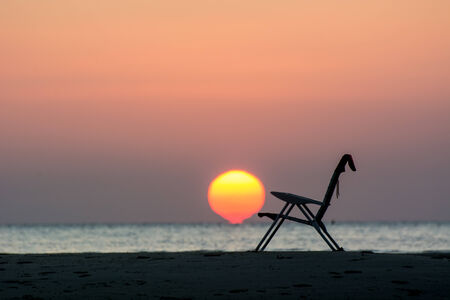 silhouette of single armchair at dusk.の写真素材