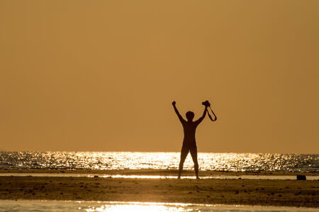 silhouette of single man action at sunset.の写真素材