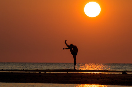 silhouette of single man action at sunset.の写真素材