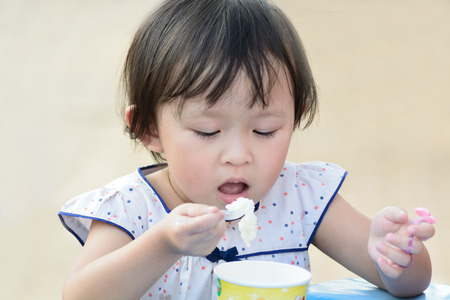 cute asian child eating.の写真素材