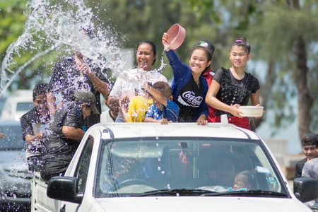KO SAMUI, THAILAND - APRIL 13: Foreigners and Thai people enjoy splashing water together in songkran...