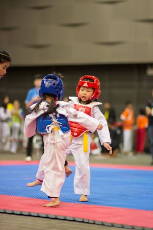 SURTTHANI, THAILAND - JULY 12: Unidentified Thai students 4 - 17 years old in action at suratthani taekwondo championship 2014 on July 12, 2014 in Suratthani, Thailand.のeditorial素材