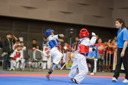 SURTTHANI, THAILAND - JULY 12: Unidentified Thai students 4 - 17 years old in action at suratthani taekwondo championship 2014 on July 12, 2014 in Suratthani, Thailand.のeditorial素材
