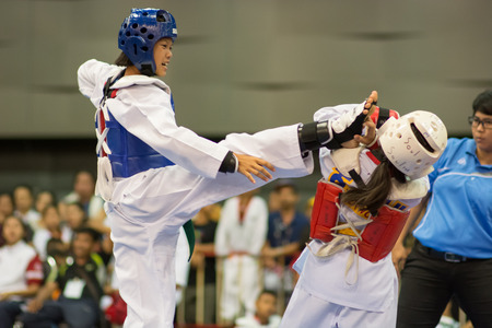 SURTTHANI, THAILAND - JULY 12: Unidentified Thai students 4 - 17 years old in action at suratthani taekwondo championship 2014 on July 12, 2014 in Suratthani, Thailand.のeditorial素材