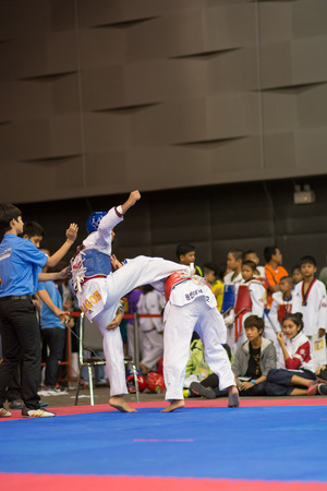 SURTTHANI, THAILAND - JULY 12: Unidentified Thai students 4 - 17 years old in action at suratthani taekwondo championship 2014 on July 12, 2014 in Suratthani, Thailand.のeditorial素材