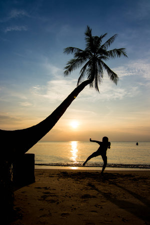 Silhouette life at sunset beach.の写真素材