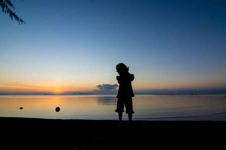 Sunset life of active kid at the beach.の写真素材