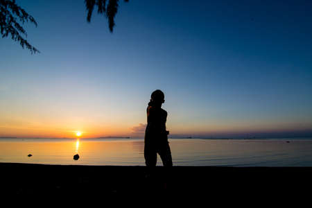 Sunset life of active kid at the beach.の写真素材