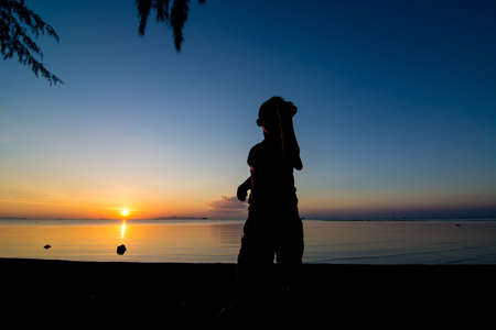 Sunset life of active kid at the beach.の写真素材