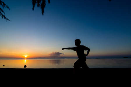 Sunset life of active kid at the beach.の写真素材