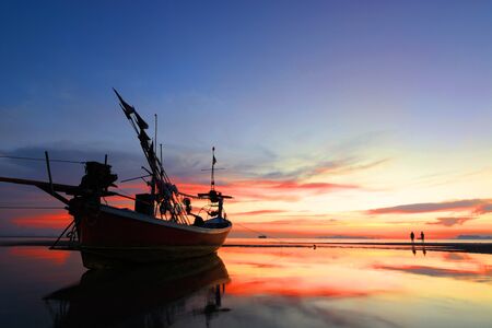 Single lonely boat on the beach at dusk, ko samui, thailand.の写真素材