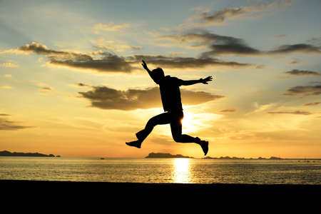 Silhouette life and activity on the beach at dusk.の写真素材
