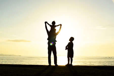 Silhouette life and activity on the beach at dusk.の写真素材