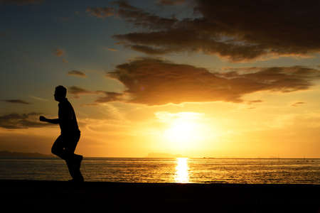 Silhouette life and activity on the beach at dusk.の写真素材