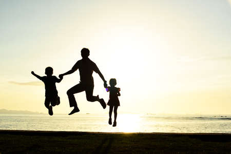 Silhouette life and activity on the beach at dusk.の写真素材