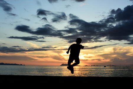 Silhouette life and activity on the beach at dusk.の写真素材