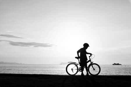 Silhouette life and activity on the beach at dusk.の写真素材