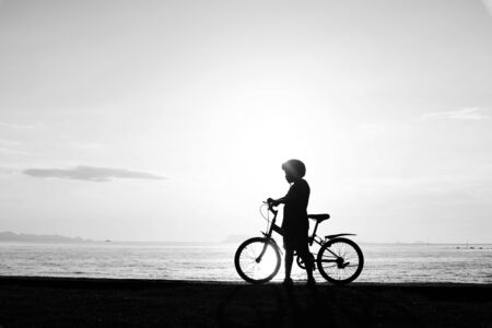 Silhouette life and activity on the beach at dusk.の写真素材