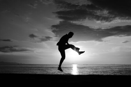 Silhouette life and activity on the beach at dusk.の写真素材
