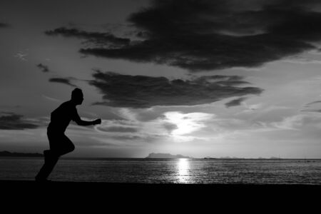 Silhouette life and activity on the beach at dusk.の写真素材