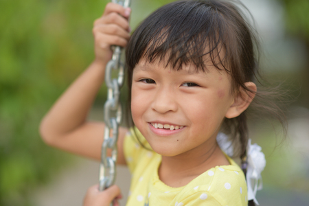 Young asian girl playing in playground.の写真素材