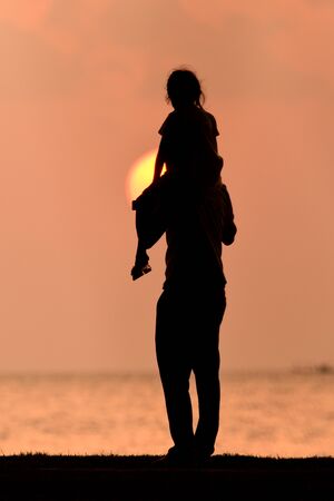 silhouette happy family at sunset.の写真素材