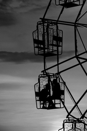 Thai rural ferris wheel silhouette at sunset.の写真素材