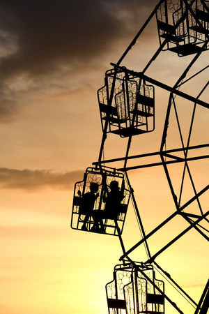 Thai rural ferris wheel silhouette at sunset.の写真素材