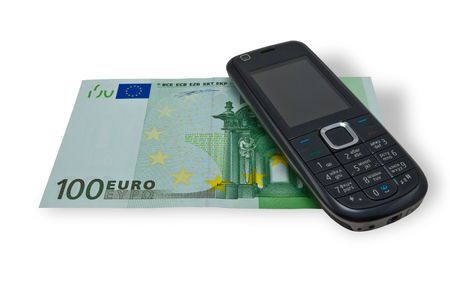 Banknote and cellular telephone on a white backgroundの写真素材