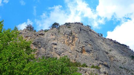 Rock on a background sky and clouds in Crimea in summerの写真素材