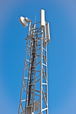 Tower with aerials of cellular on a background mountains and blue skyの写真素材