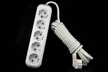 A basic surge protector electric outlet isolated on black backgroundの写真素材