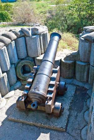 Retro black metal gun in the fortification の写真素材