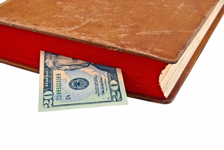 Dollar in the book, isolated on white backgroundの写真素材