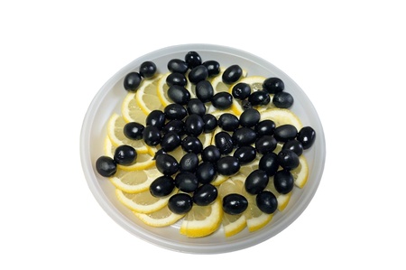 Plate of black olives arranged with lemonの写真素材