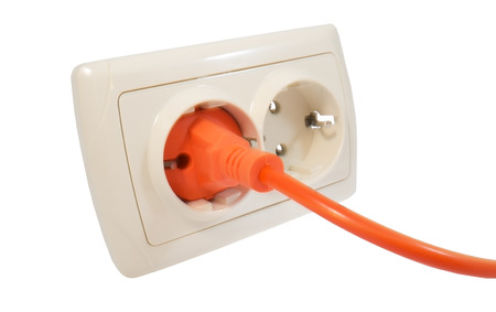 power plug into power outlet against a white background