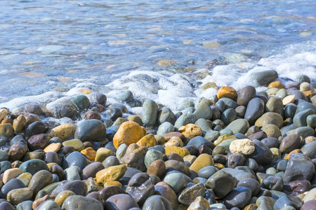 The small smooth multi-coloured sea stonesの写真素材