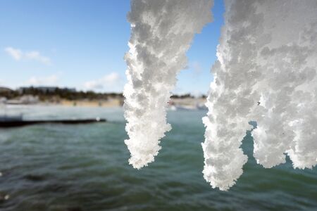 Row of icicles on the background of the sea