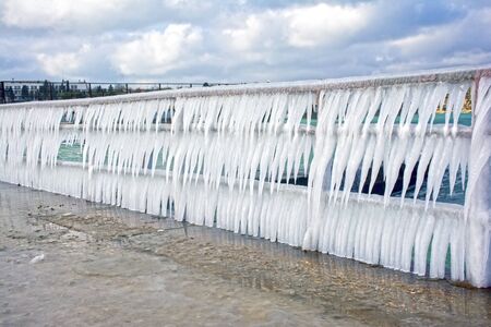 Row of icicles on the background of the seaの写真素材