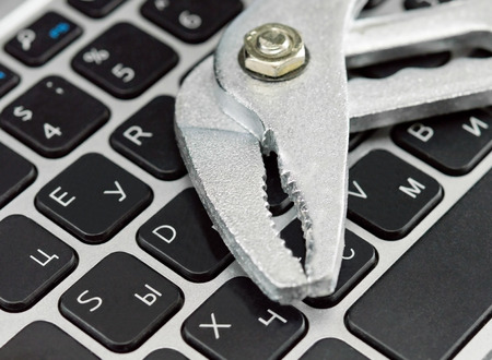 laptop Keyboard and big Wrench