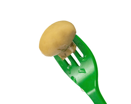 mushroom on fork, isolated on white background