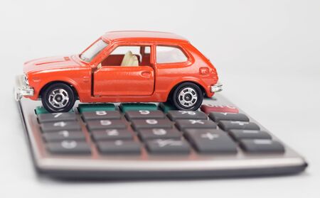 car and calculator on white backgrounの写真素材