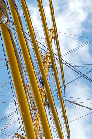 Masts and rigging of a sailing ship against blue sky and cloudsの写真素材