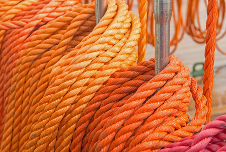 Reeled ship ropes hanging on the spoolsの写真素材