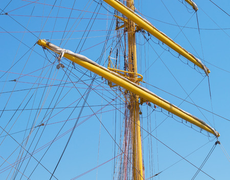 Masts and rigging of a sailing ship against blue sky and cloudsの写真素材