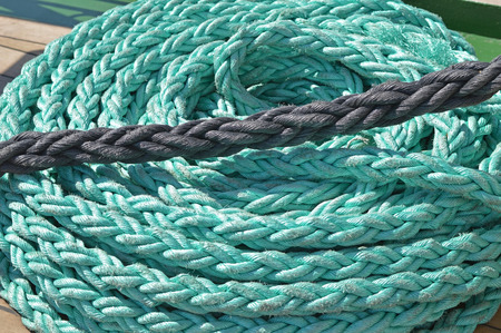 Coiled rope on a the deck of the sailboatの写真素材
