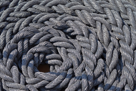 Coiled rope on a the deck of the sailboatの写真素材