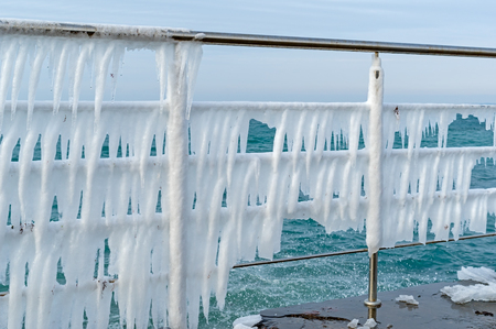 Row of icicles on the Chromium metal fence with handrailの写真素材