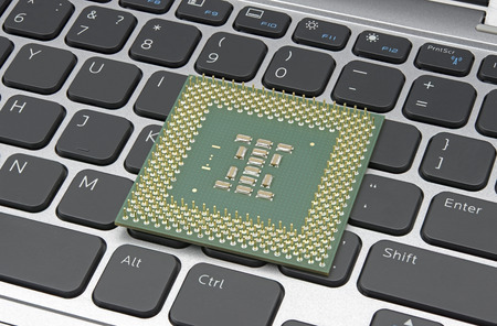 Modern CPU on background laptop keyboardの写真素材