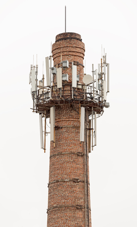 brick power plant pipe with cellular aerials on white backgroundの写真素材